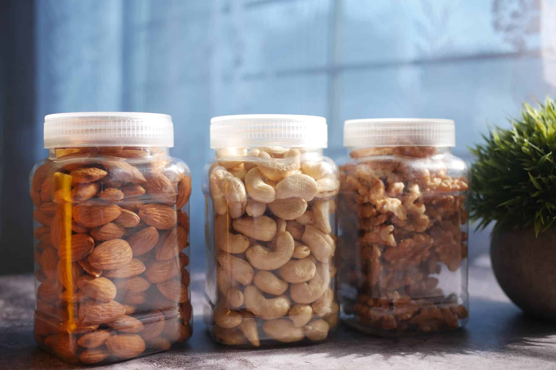 a variety of nuts in clear jars